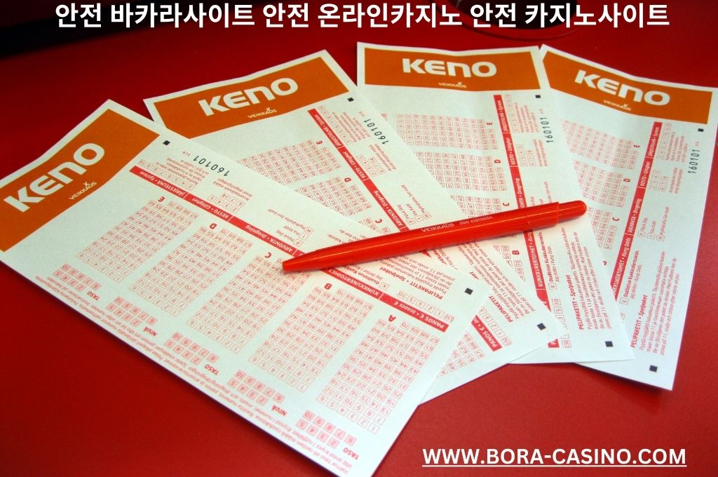 Four keno lottery tickets and one orange pen 