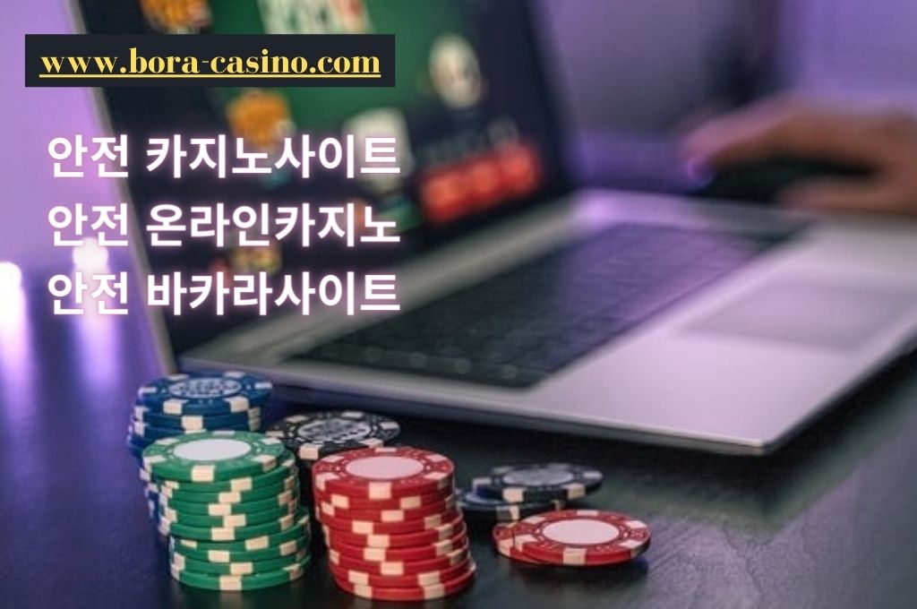 gambler play online casino in his laptop and on then side where the casino chips placed